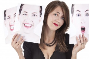 Woman Holding Photographs of Her Emotions
